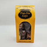 Yellow packaging box with 'Punta Clara Kitchen' branding conatining assorted coated pecans