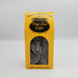 Dark chocolate coated pecans in yellow punta clara kitchen box