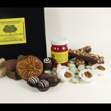 Closeup of Punta Clara Kitchen gift box of Assorted candies including bourbon balls, divinity and a jar of jelly 
