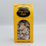 Yellow packaging of Punta Clara Kitchen with a clear window showing pralive flavor coated pecans